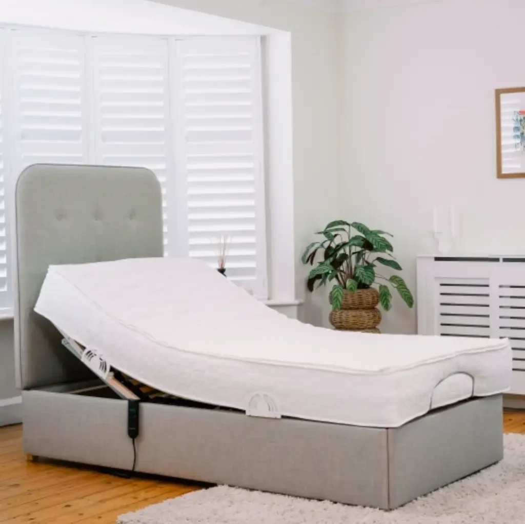 Electric adjustable bed with raised head section in modern UK bedroom